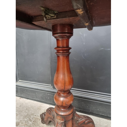 1034 - A Victorian mahogany tripod table, with quarter veneered top, 68cm wide.