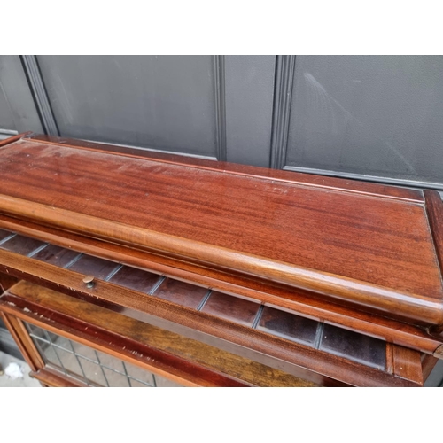 1038 - An early 20th century Globe Wernicke mahogany four tier sectional bookcase, with leaded glass panels... 