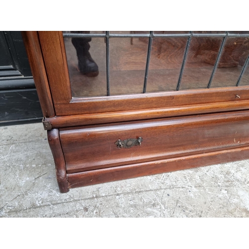 1038 - An early 20th century Globe Wernicke mahogany four tier sectional bookcase, with leaded glass panels... 