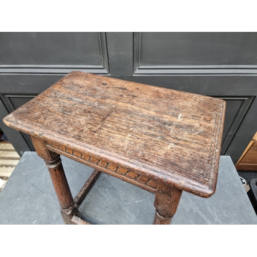 1041 - A 17th century carved oak joint stool, 49cm wide.  