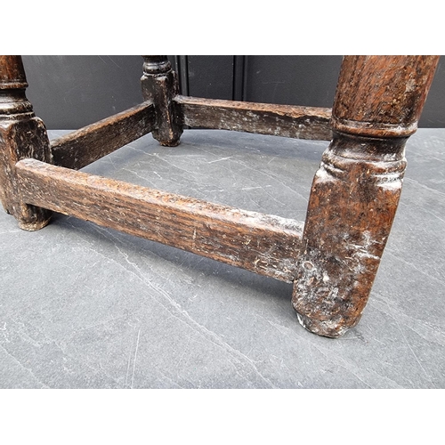 1041 - A 17th century carved oak joint stool, 49cm wide.  