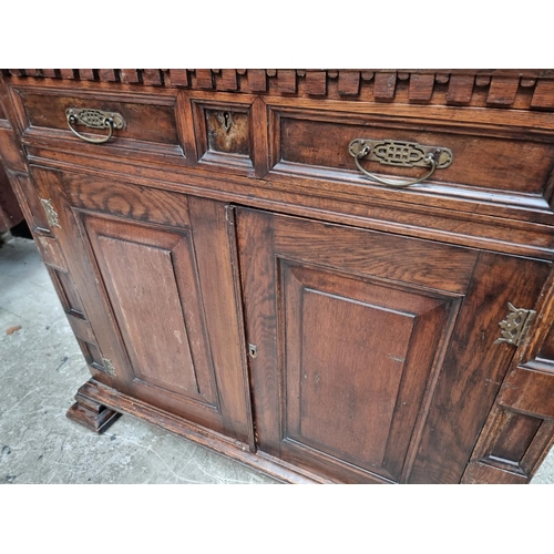 1048 - An antique oak panelled side cabinet, 102.5cm wide. 