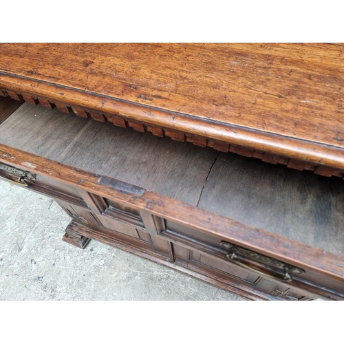 1048 - An antique oak panelled side cabinet, 102.5cm wide. 