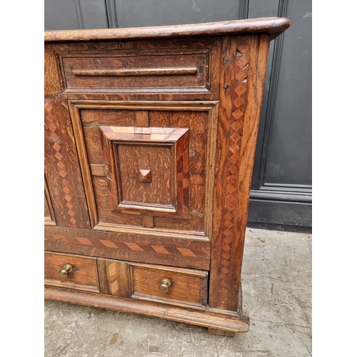 1051 - A late 17th century panelled oak and parquetry mule chest, 129.5cm wide. 