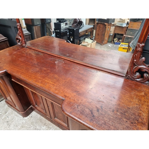 1054 - A large Victorian mahogany inverted breakfront mirror back sideboard, 196cm wide.