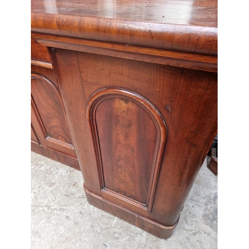 1054 - A large Victorian mahogany inverted breakfront mirror back sideboard, 196cm wide.