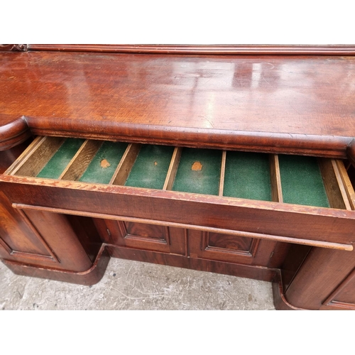 1054 - A large Victorian mahogany inverted breakfront mirror back sideboard, 196cm wide.