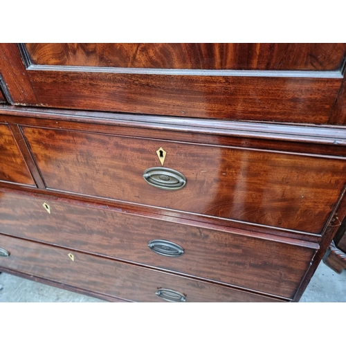 1061 - A large George IV mahogany linen press, possibly Scottish, with five sliding trays and bone escutche... 