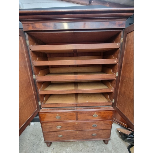 1061 - A large George IV mahogany linen press, possibly Scottish, with five sliding trays and bone escutche... 