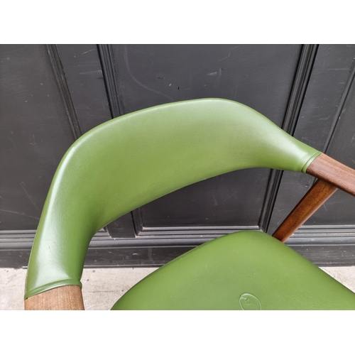 1073 - A vintage teak and green vinyl elbow chair, in the manner of Guilleumas. 