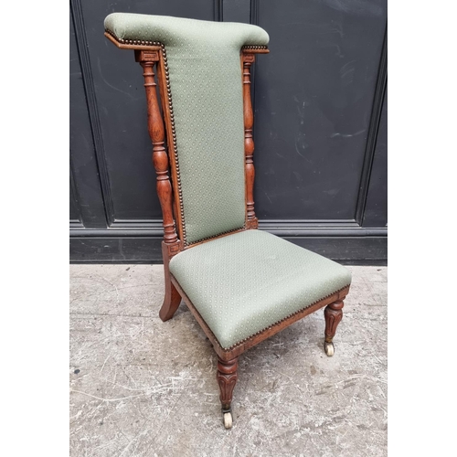 1074 - A Victorian oak and upholstered prie dieu chair.    