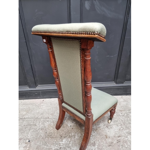 1074 - A Victorian oak and upholstered prie dieu chair.    