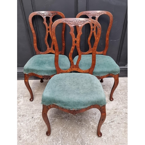 1082 - A set of three 18th century Dutch carved walnut and marquetry dining chairs. (3)