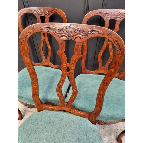 1082 - A set of three 18th century Dutch carved walnut and marquetry dining chairs. (3)