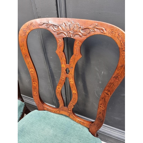 1082 - A set of three 18th century Dutch carved walnut and marquetry dining chairs. (3)