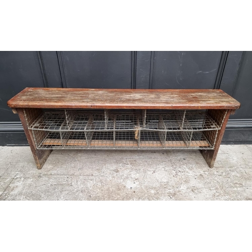 1090 - A vintage stained pine combined bench and shoe rack, 128cm wide.