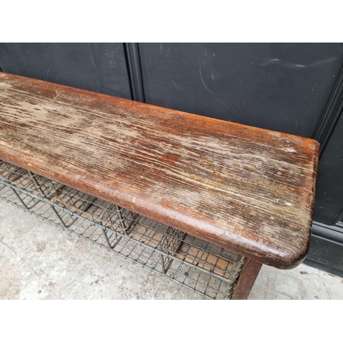 1090 - A vintage stained pine combined bench and shoe rack, 128cm wide.