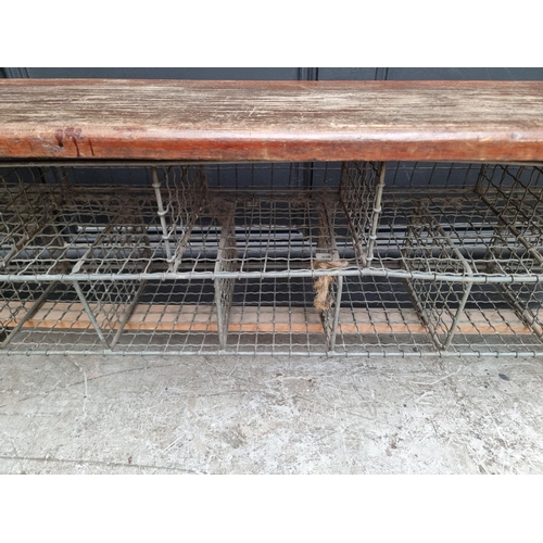 1090 - A vintage stained pine combined bench and shoe rack, 128cm wide.