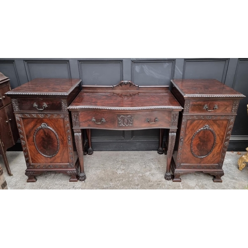 1091 - An early 20th century carved mahogany serpentine fronted sideboard and matching pedestals, 107cm wid... 