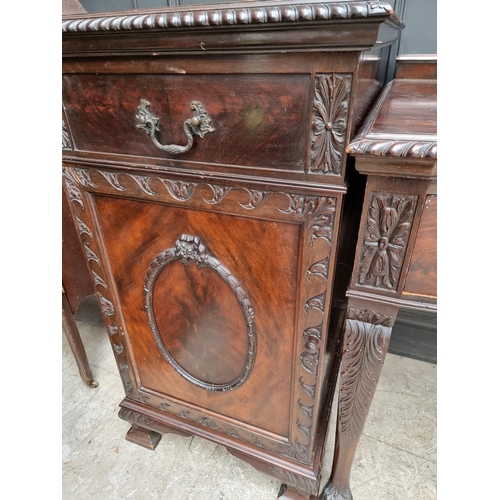 1091 - An early 20th century carved mahogany serpentine fronted sideboard and matching pedestals, 107cm wid... 