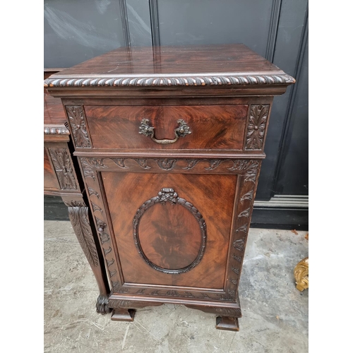 1091 - An early 20th century carved mahogany serpentine fronted sideboard and matching pedestals, 107cm wid... 