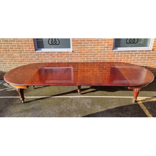 1093 - A large Victorian mahogany extending dining table and matching leaf cabinet, with four leaves, ... 