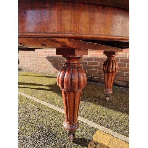 1093 - A large Victorian mahogany extending dining table and matching leaf cabinet, with four leaves, ... 