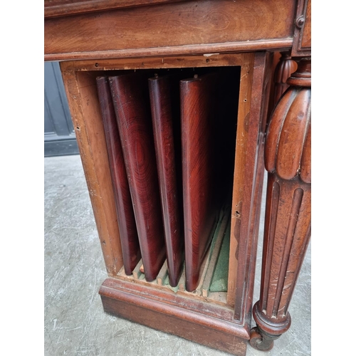 1093 - A large Victorian mahogany extending dining table and matching leaf cabinet, with four leaves, ... 