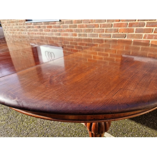 1093 - A large Victorian mahogany extending dining table and matching leaf cabinet, with four leaves, ... 