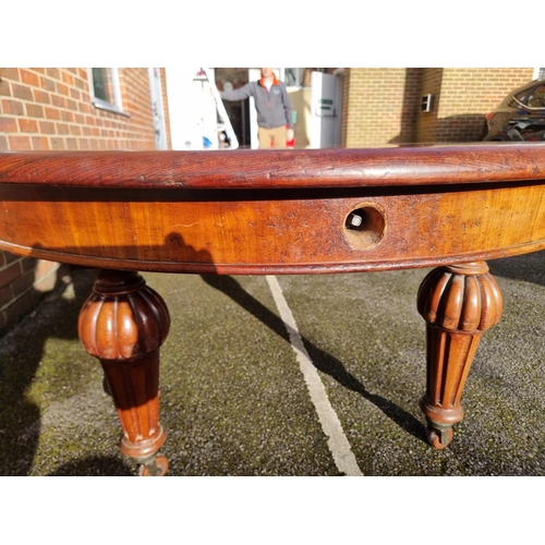 1093 - A large Victorian mahogany extending dining table and matching leaf cabinet, with four leaves, ... 