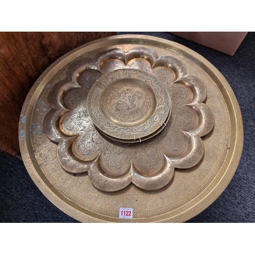 1122 - An Islamic brass tray, 64cm diameter, on associated hardwood stand; together with another India... 