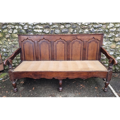 1131 - A George III oak, fruitwood and mahogany settle, 186.5cm wide, (wormed). 