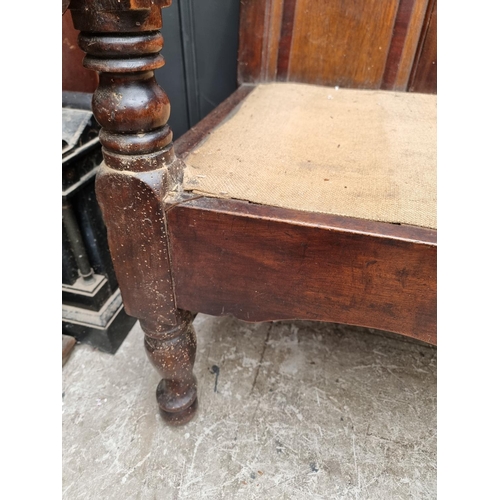 1131 - A George III oak, fruitwood and mahogany settle, 186.5cm wide, (wormed). 