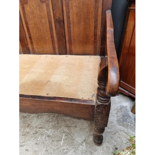 1131 - A George III oak, fruitwood and mahogany settle, 186.5cm wide, (wormed). 