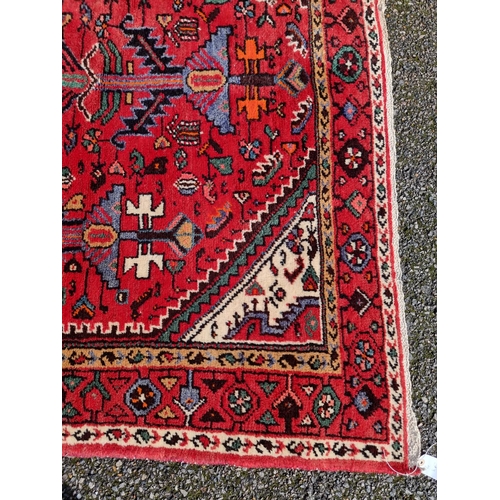 1138 - An Iranian rug, with tribal and geometric decoration to central field, 280 x 141cm.