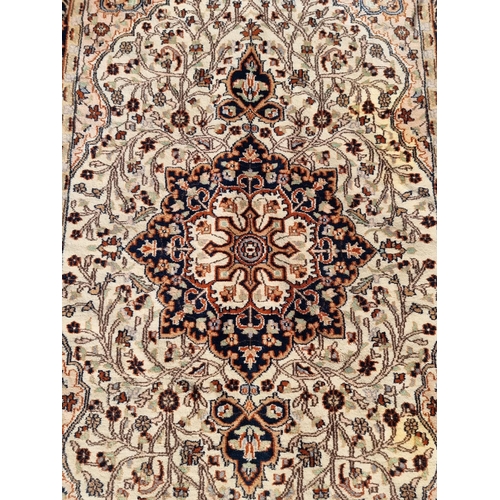 1142 - A Persian rug, having central floral medallion, with floral borders, 202 x 127cm.