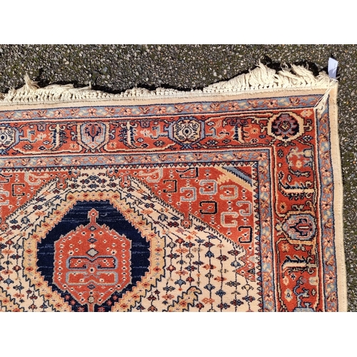 1144 - A Persian rug, having geometric cartouches to each corner, 210 x 140cm.