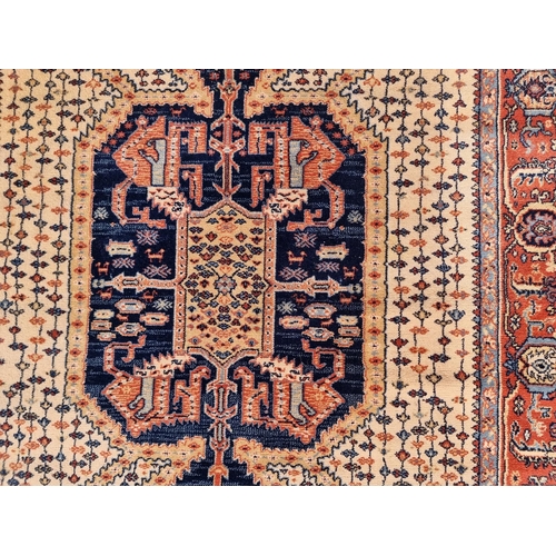 1144 - A Persian rug, having geometric cartouches to each corner, 210 x 140cm.