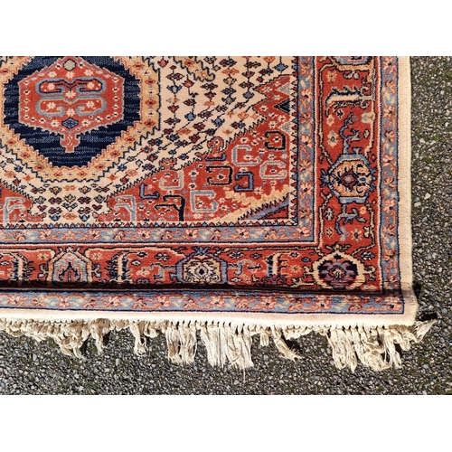 1144 - A Persian rug, having geometric cartouches to each corner, 210 x 140cm.