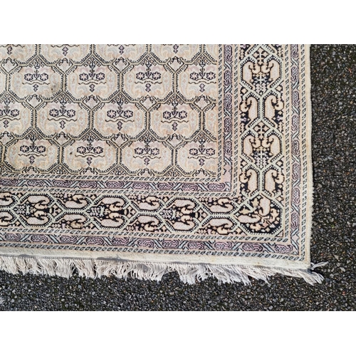 1145 - A Kashmiri rug, having repeated decoration to central field, geometric borders on a cream and black ... 