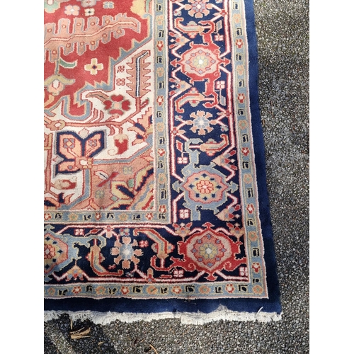 1147 - A large carpet, having central star medallion, with floral cartouches to each corner, with floral bo... 