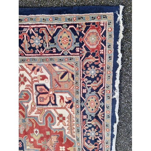 1147 - A large carpet, having central star medallion, with floral cartouches to each corner, with floral bo... 