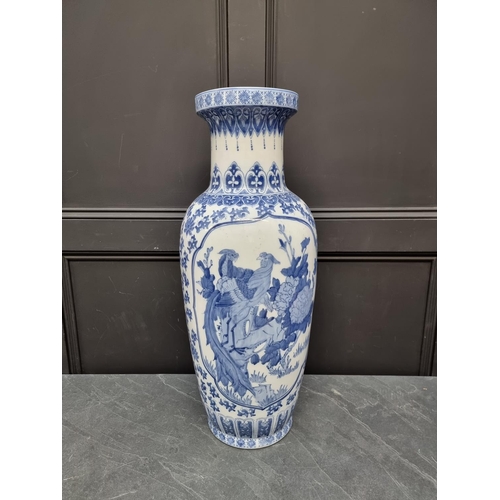 1169 - A large modern Chinese blue and white vase, 77cm high, on hardwood stand.