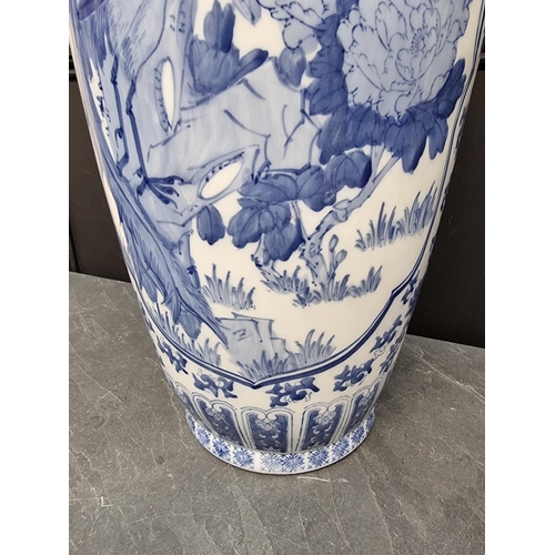 1169 - A large modern Chinese blue and white vase, 77cm high, on hardwood stand.