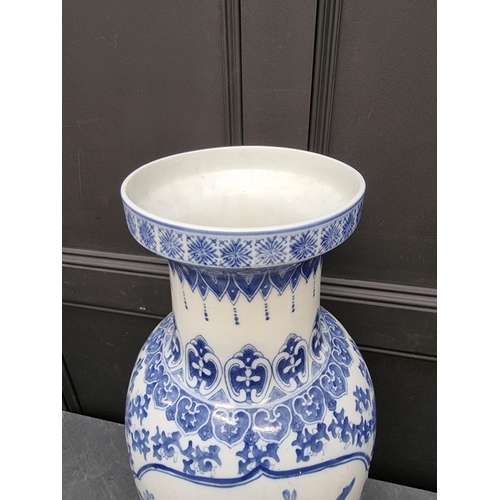 1169 - A large modern Chinese blue and white vase, 77cm high, on hardwood stand.