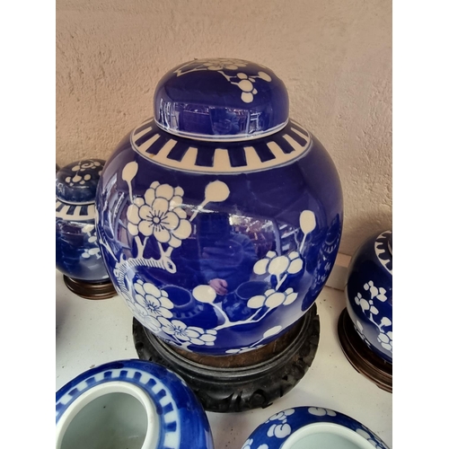 1203 - Thirteen Chinese blue and white jars and six covers, largest 20cm high, and three wood stands.... 