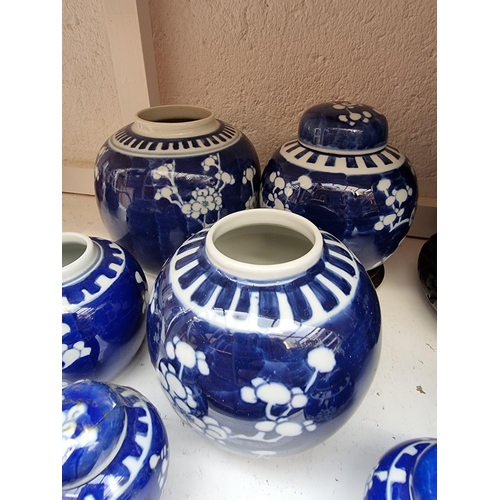 1203 - Thirteen Chinese blue and white jars and six covers, largest 20cm high, and three wood stands.... 