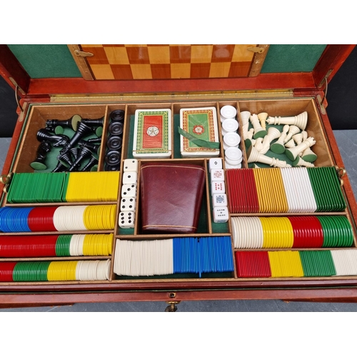 1219 - A leather cased games compendium, 55cm wide.