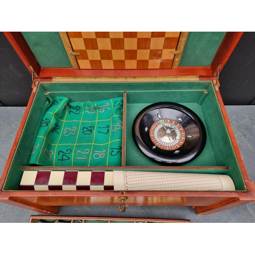 1219 - A leather cased games compendium, 55cm wide.