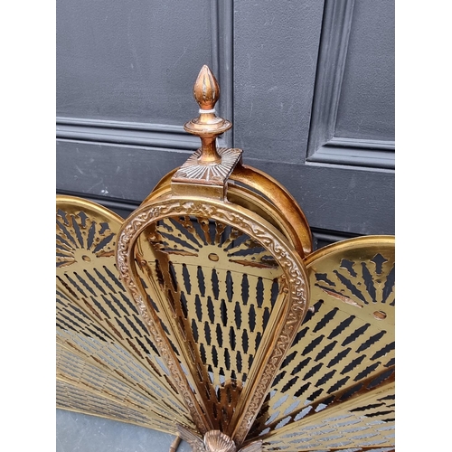 1220 - A vintage brass folding fireguard, 62.5cm high.